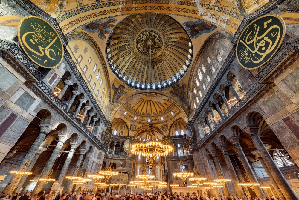 Hagia Sophia interior view with central dome, upper gallery arches, and historic Byzantine architecture in Istanbul