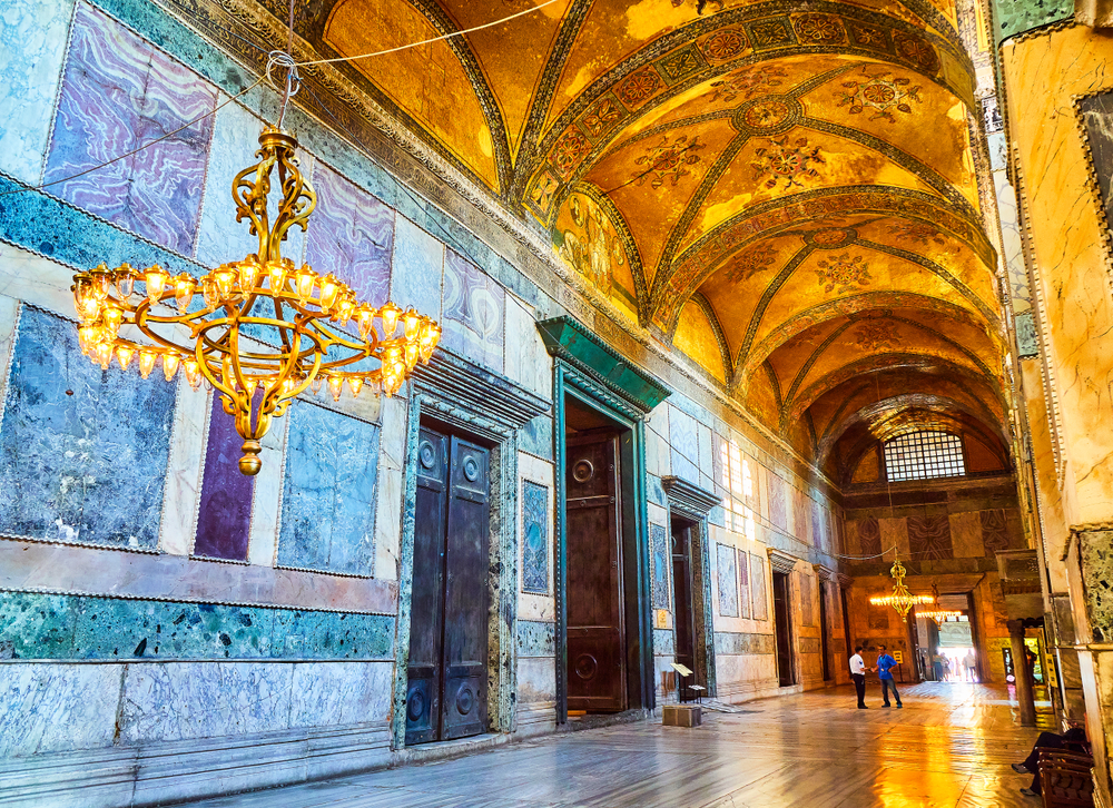 Hagia Sophia Imperial Gate interior with historic bronze doors and Byzantine mosaic above the ceremonial entrance in Istanbul