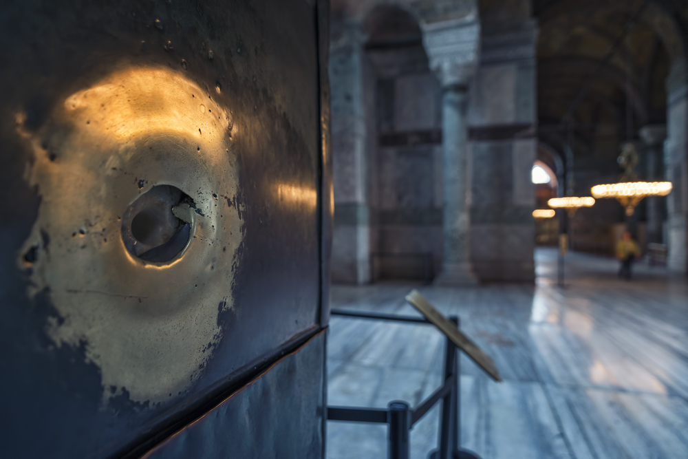 Hagia Sophia Wishing Column close-up with famous marble surface and finger hole inside the historic interior